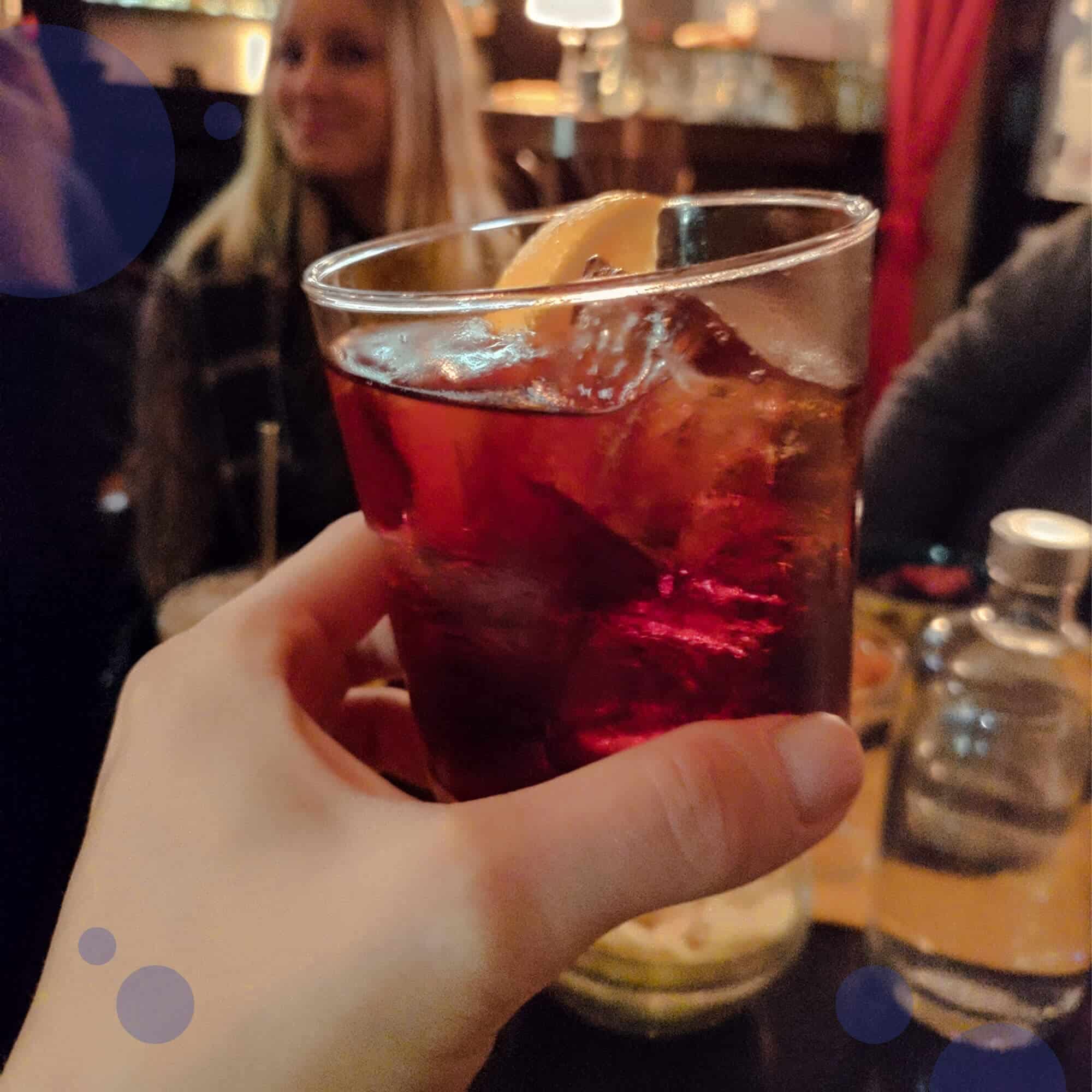 A person holding a drink in their hand