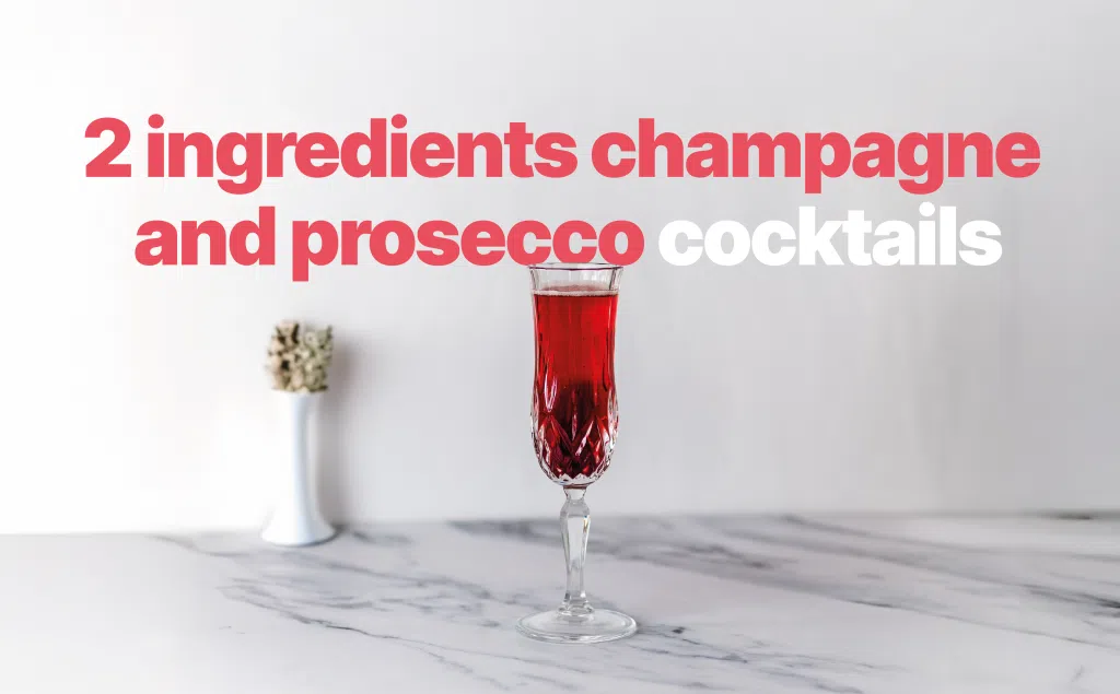 A shot of a champagne cocktail in a champagne flute on a white marmol surface in front of a white background