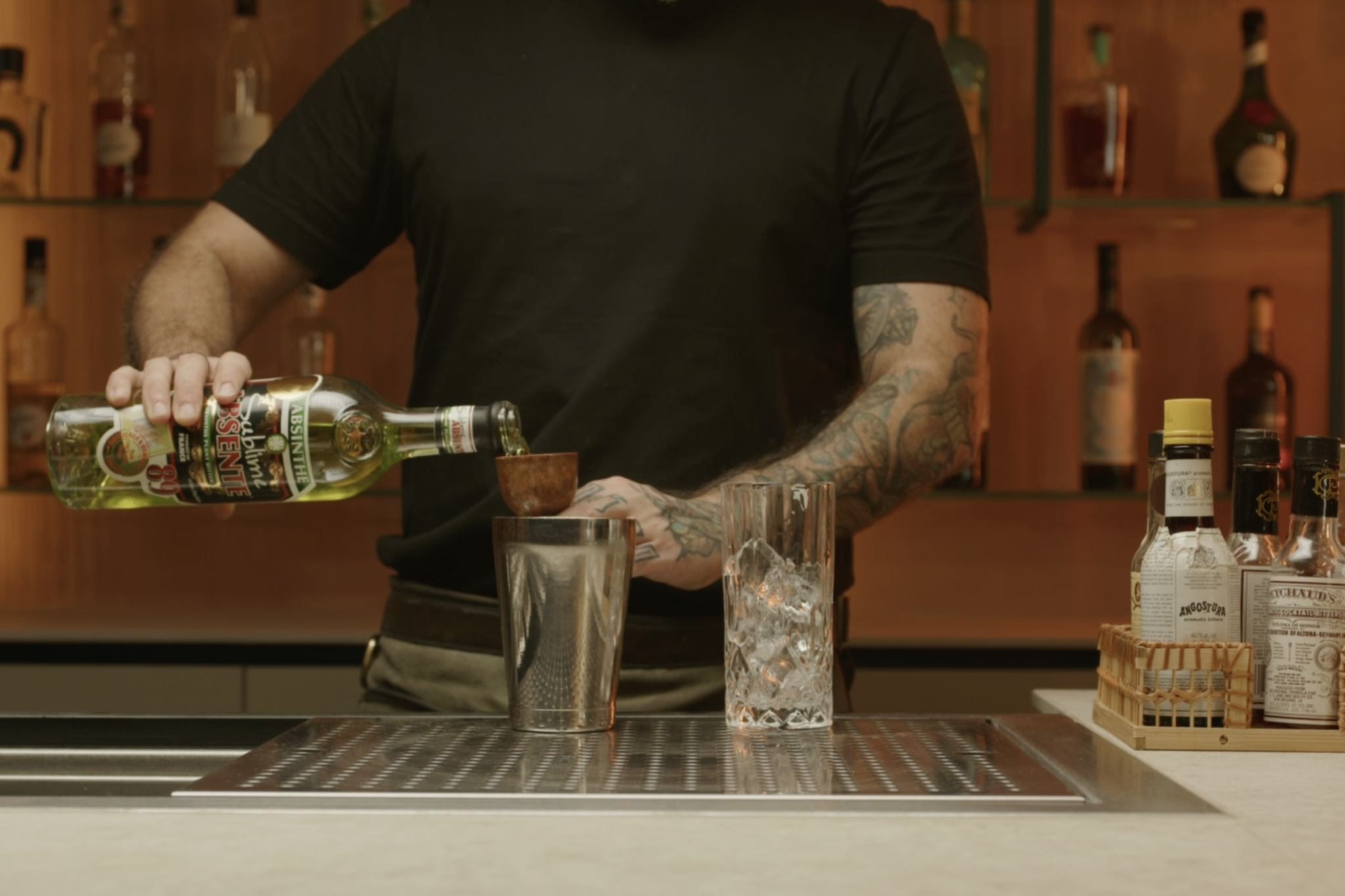 <p>Next, measure 1 ½ ounces of absinthe, either green or white, and pour it into the shaker. Absinthe, known for its strong anise and herbal flavor profile, forms the backbone of this cocktail.</p>