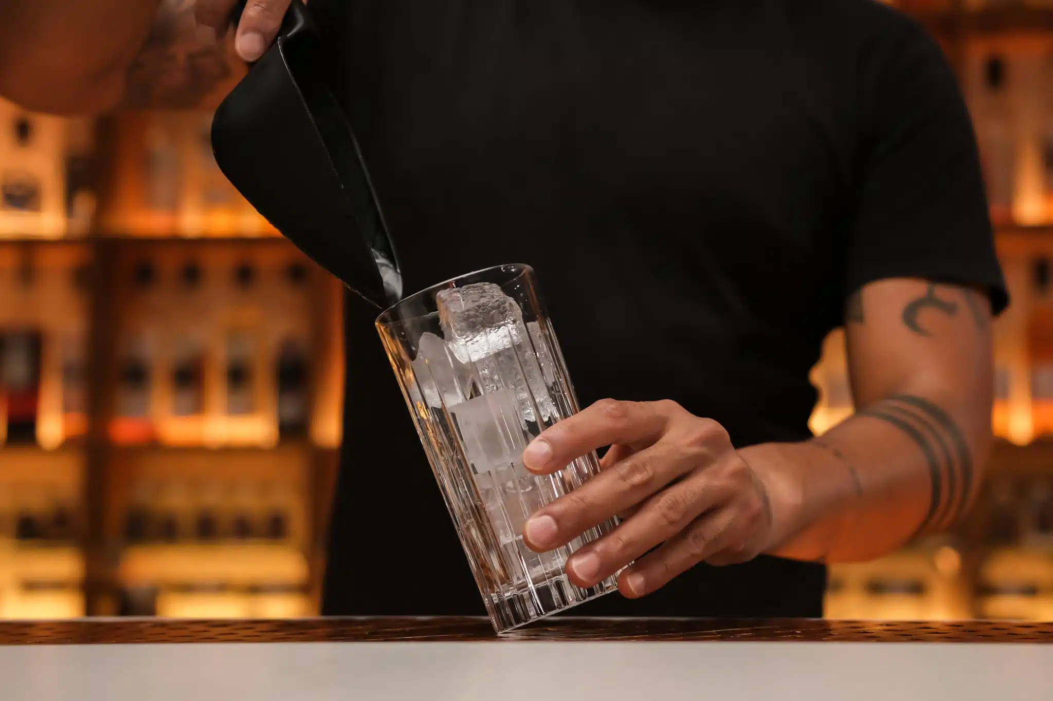 <p>First, fill your highball glass with ice cubes to prepare it for the cocktail.</p>
