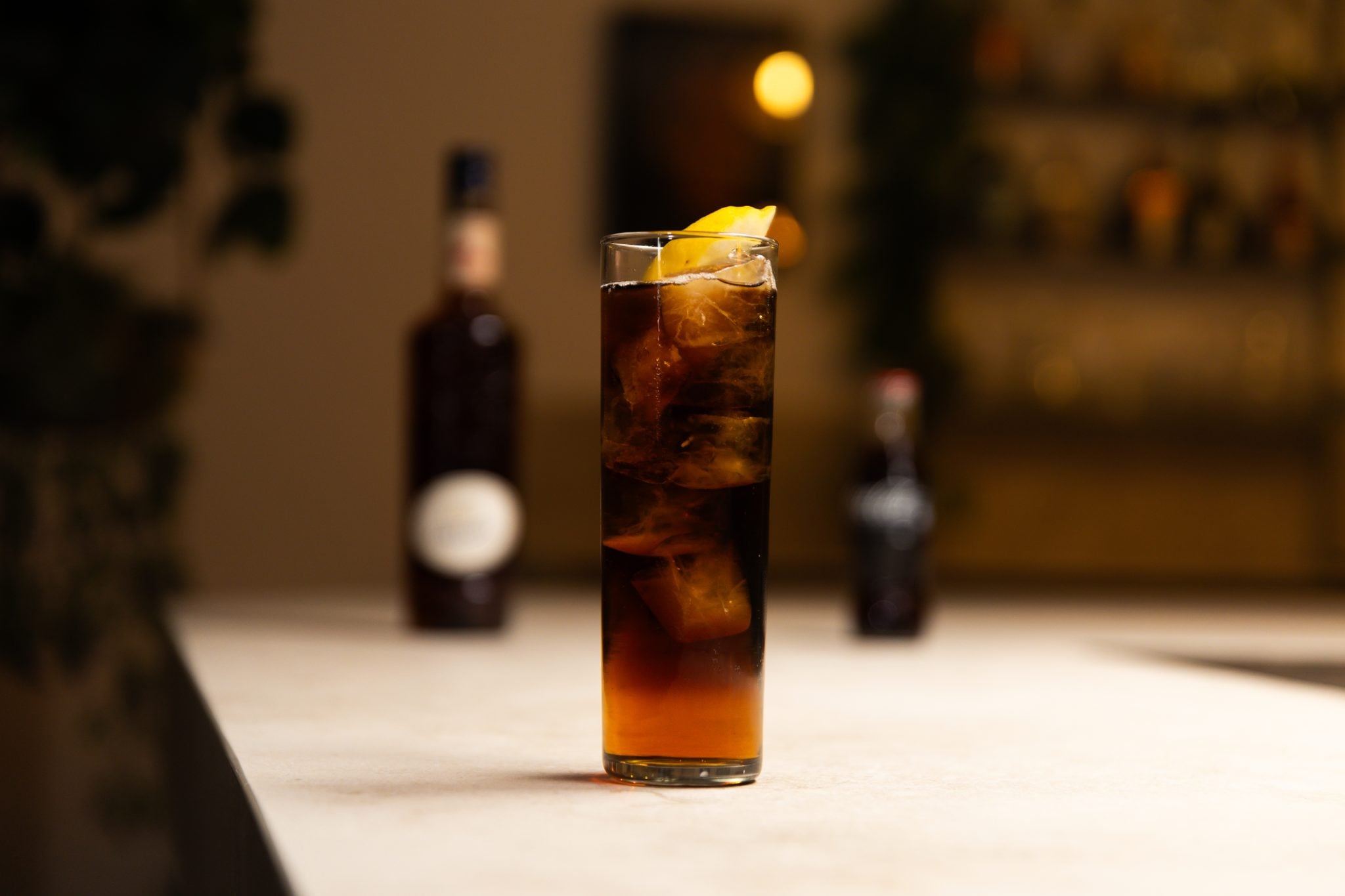 Amaretto and Coke laid out on a white bar table