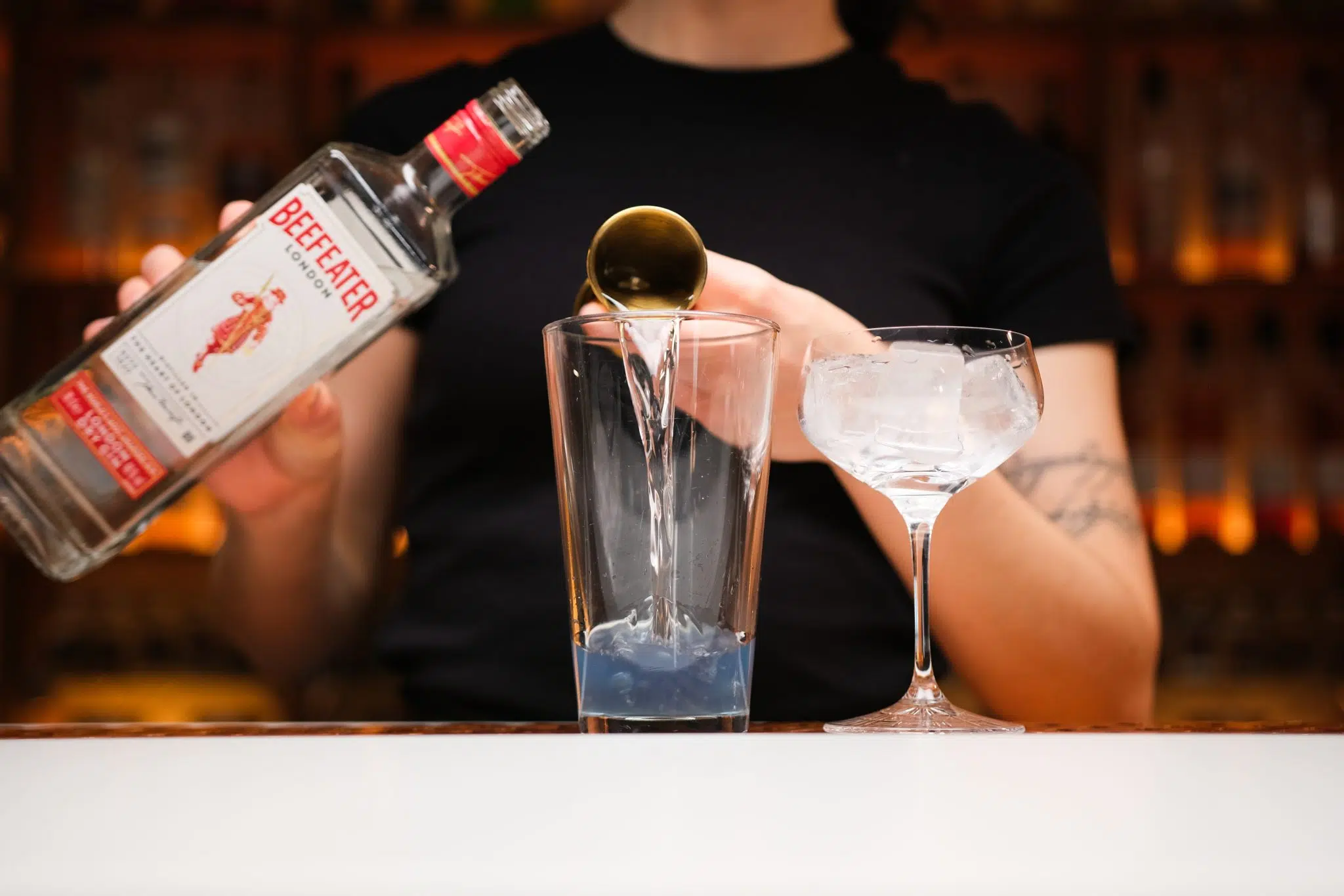 <p>Next, pour 2 oz of Gin into the shaker. Gin acts as the foundational spirit for this cocktail, providing its distinctive botanical flavor.</p>
