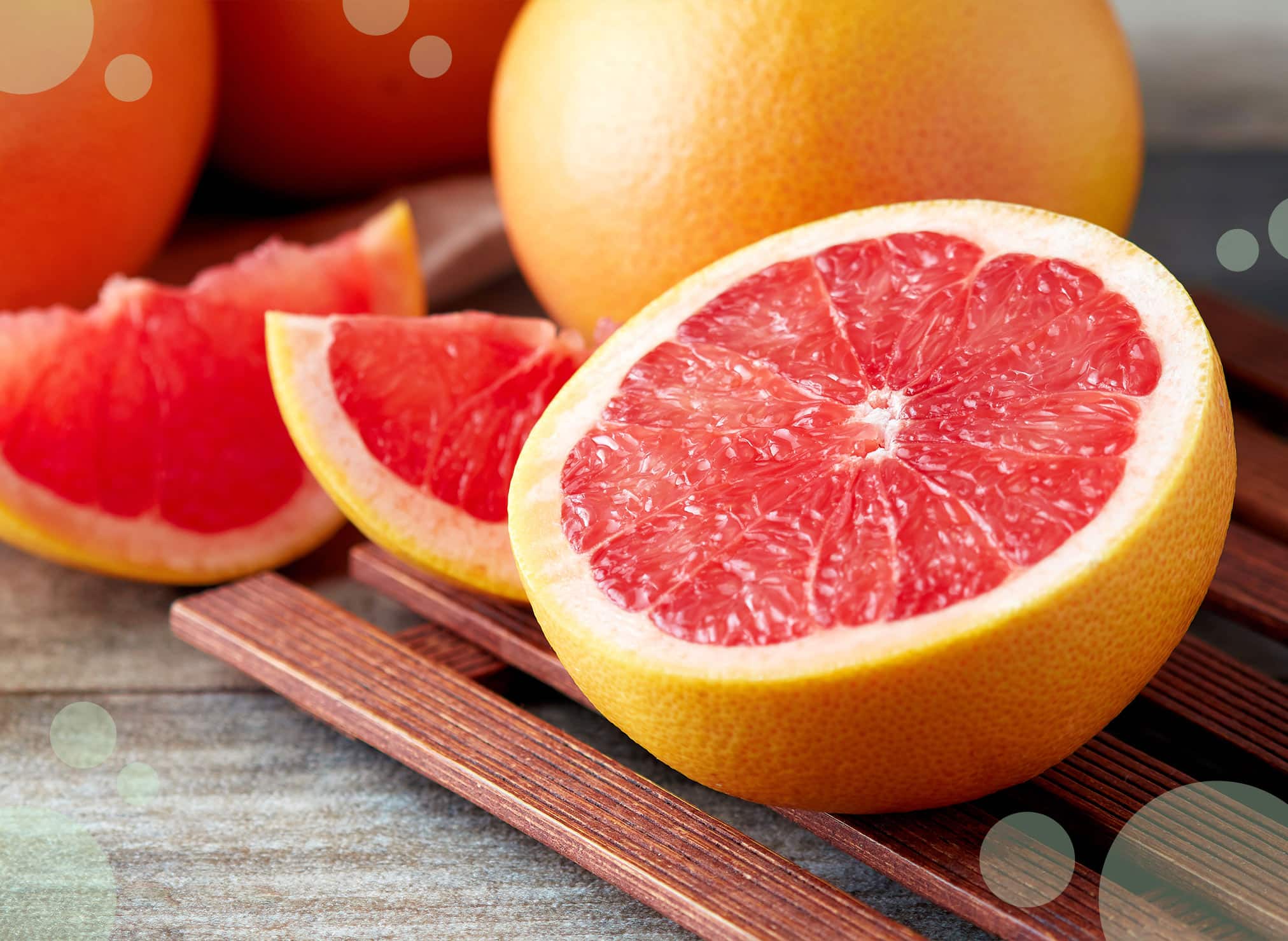 Grapefruit pieces cutted into different shapes on a slatted tray.