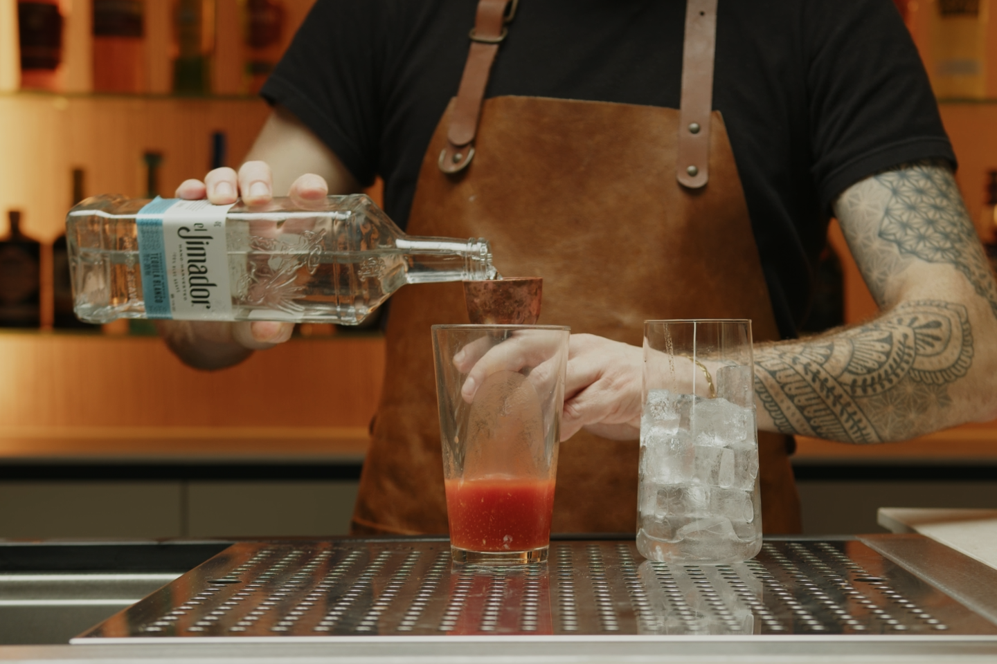 <p>Measure and pour 2 oz of tequila into the shaker. The Tequila is the leading spirit in Bloody Maria, replacing the vodka typically found in Bloody Mary.</p>
