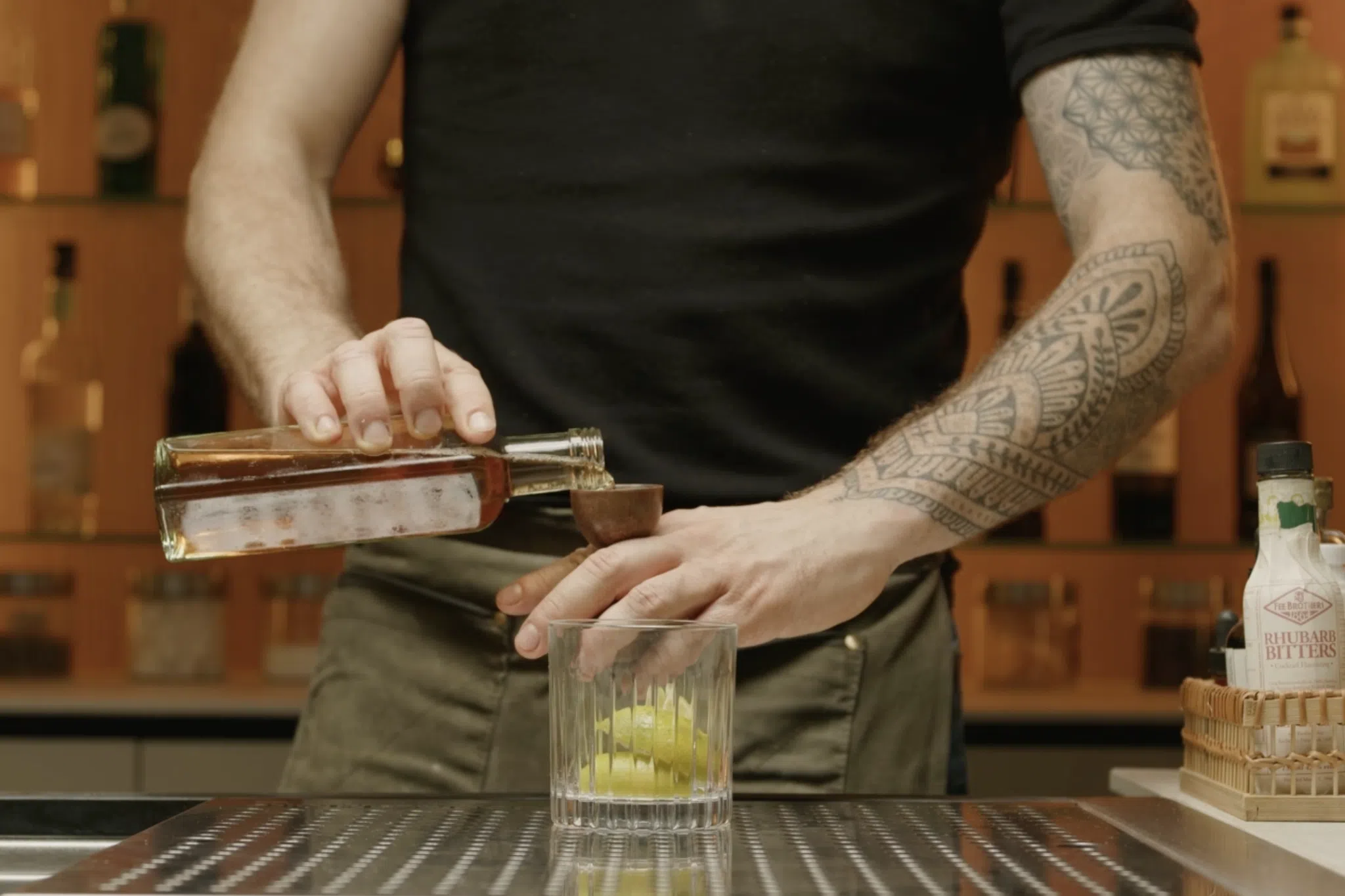 Demerara syrup poured into old fashioned glass with jigger
