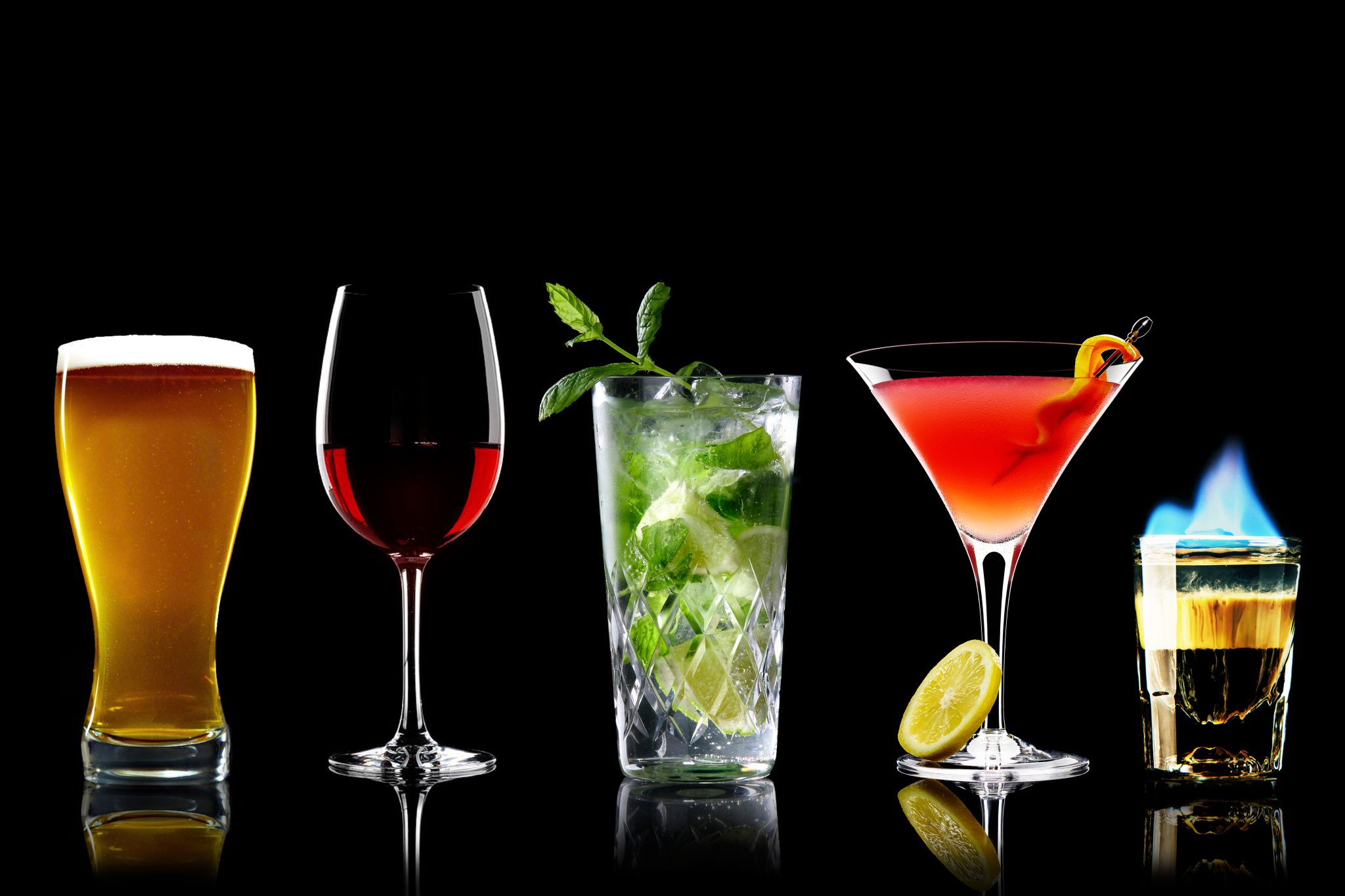 A shot of five different drinks (beer, wine, highball cocktail, martini cocktail and shot) on a black background