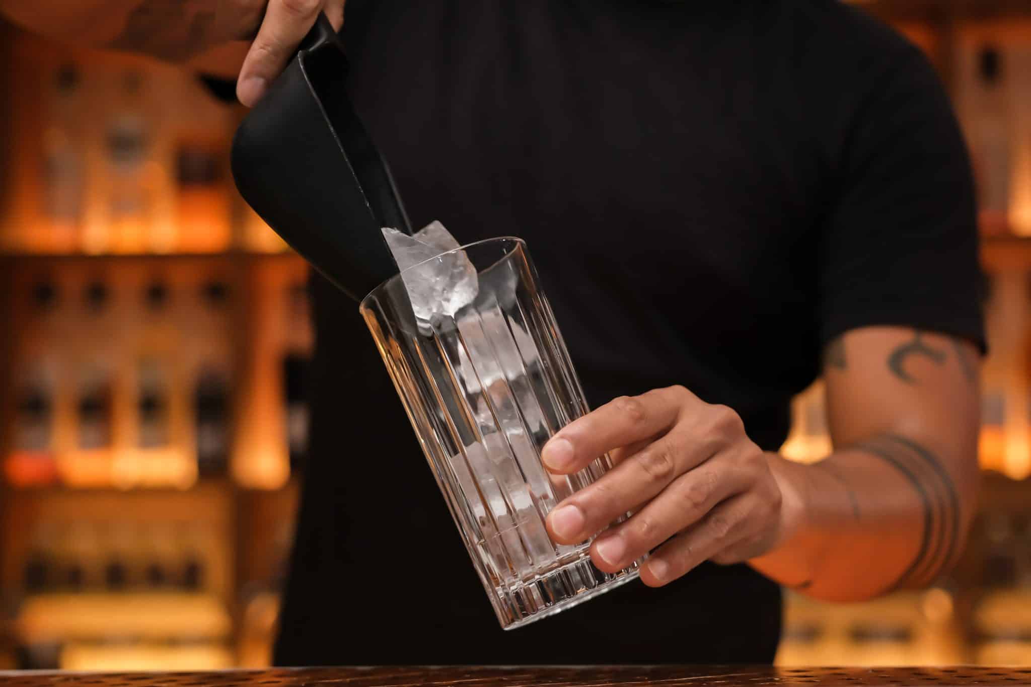 <p>Start by filling a highball glass with ice cubes. This ensures your cocktail is chilled and refreshing.</p>
