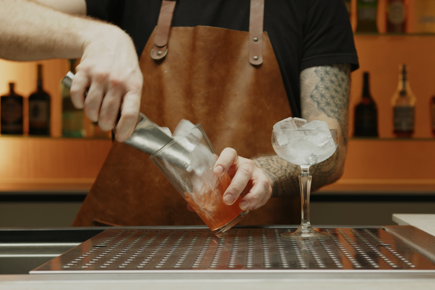 <p>Fill your cocktail shaker with ice cubes.</p>
