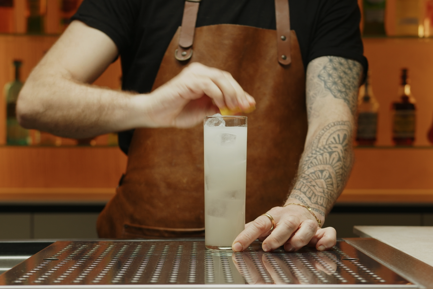 <p>Finally, garnish the cocktail with a lemon zest. Start by squeezing the lemon zest on top of the drink.</p>
