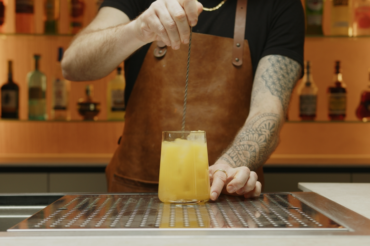 <p>Stir the mixture gently with a cocktail stirrer or a long spoon. This will combine the peach schnapps and orange juice while adding a little dilution and cooling the cocktail down.</p>
