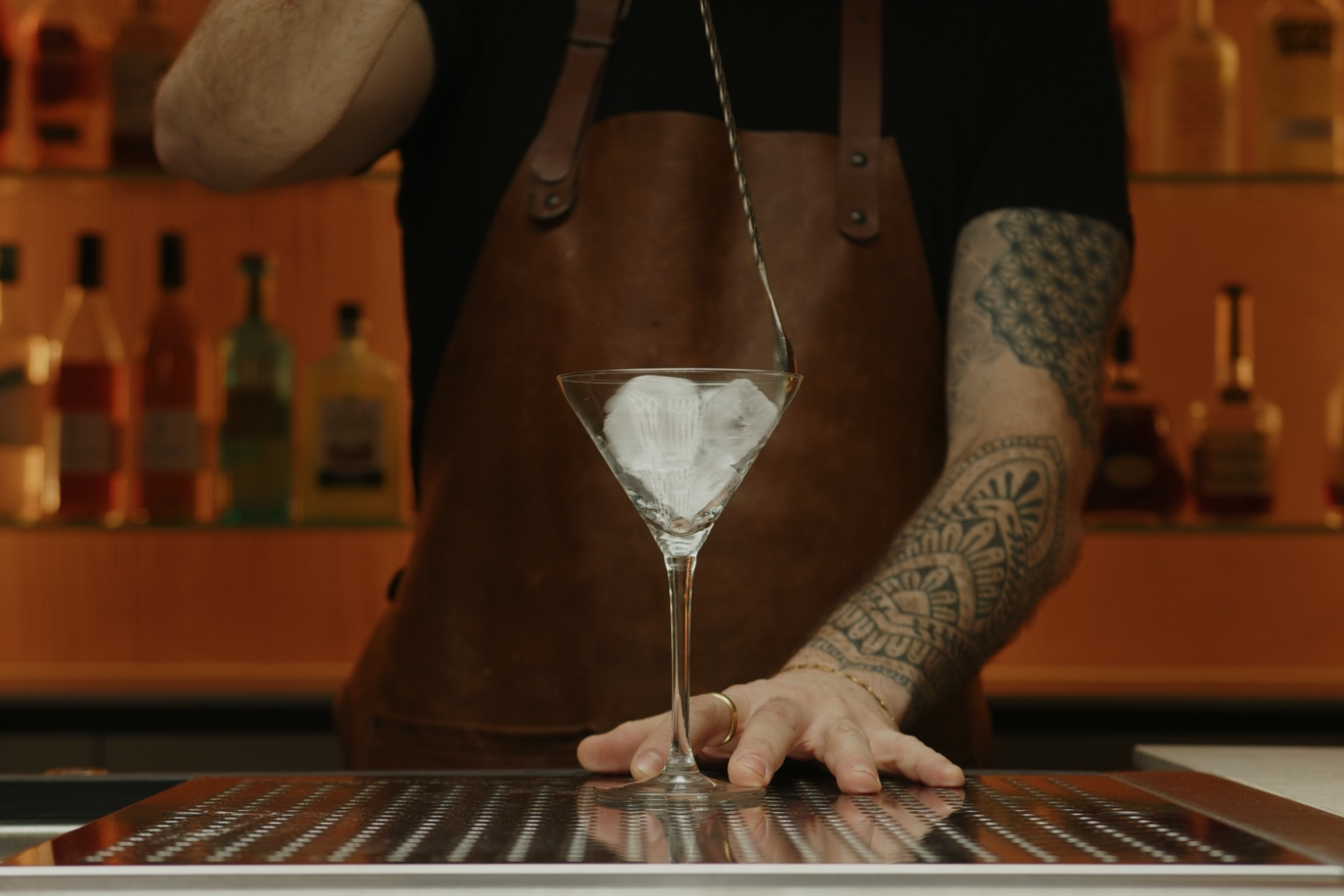 <p>Begin by filling a cocktail glass (coupe or Martini style) with ice. Set it aside.</p>