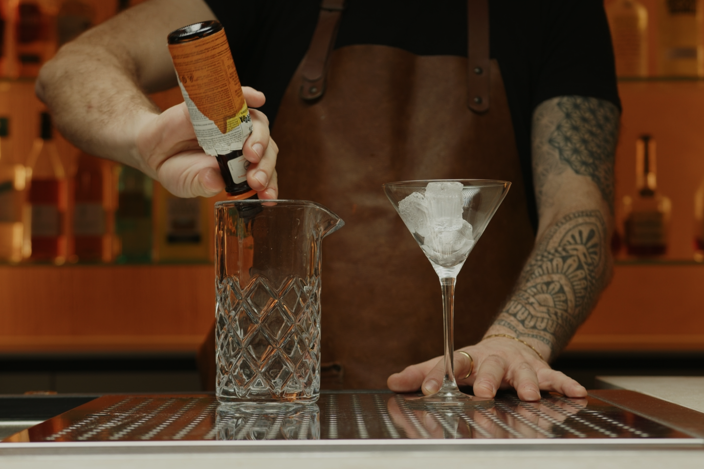 <p>Pour 2 dashes of Orange Bitters into the mixing glass.</p>