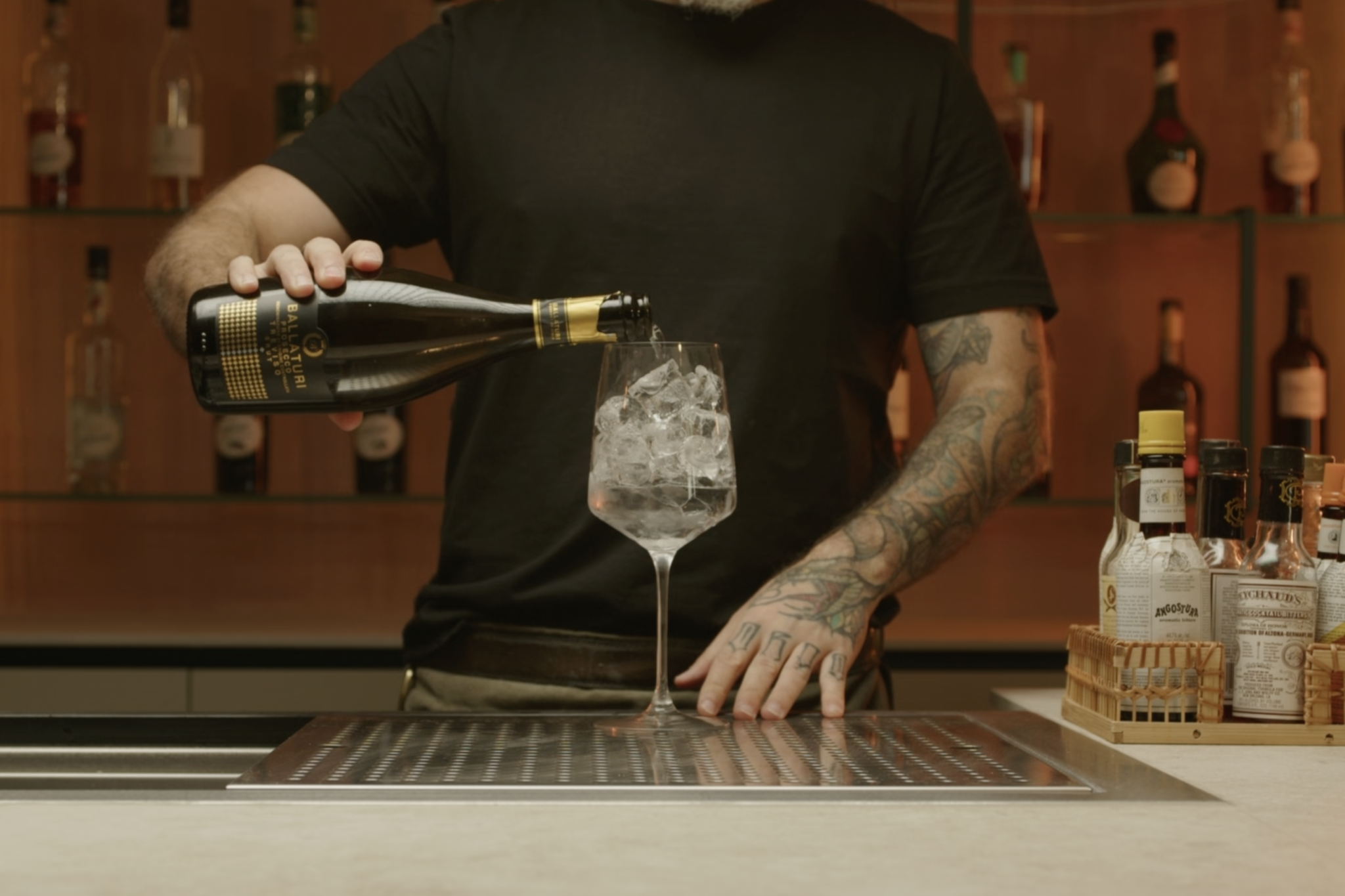 <p>Pour approximately 3 oz of prosecco into the glass, adding a bubbly, slightly sweet element.</p>