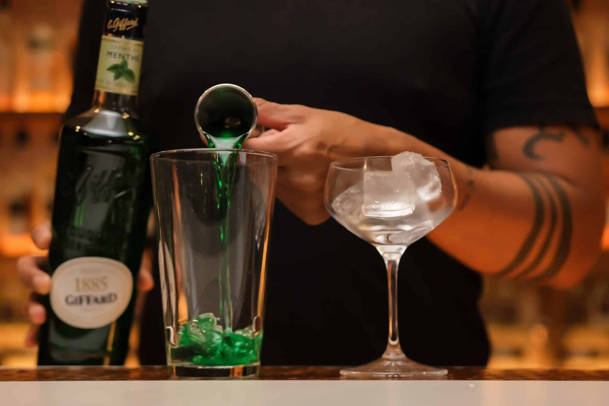 <p>Pour 1 oz of crème de menthe into the ice-filled shaker to give the drink its minty kick.</p>
