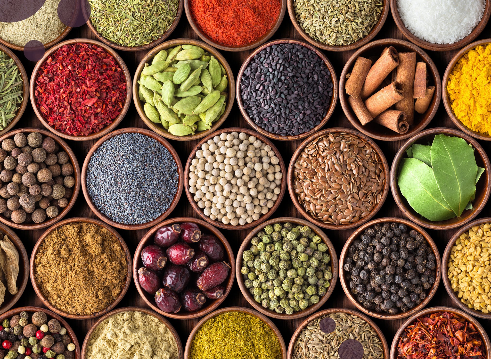 Many bowls with grains, spices and leaves.