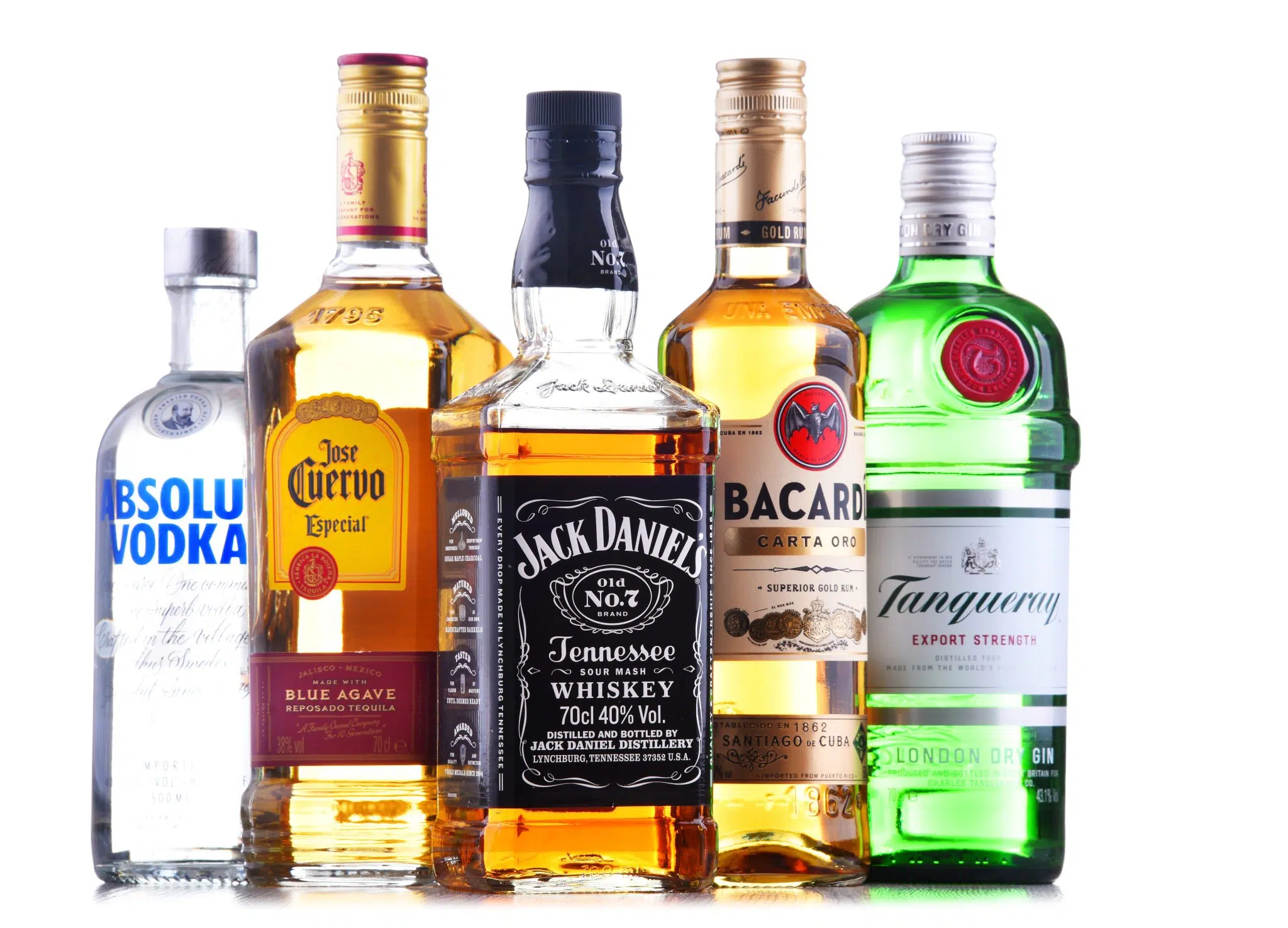 A shot of five bottles of different Liquors (vodka, tequila, whiskey, rum and gin) and brands in front of a white background