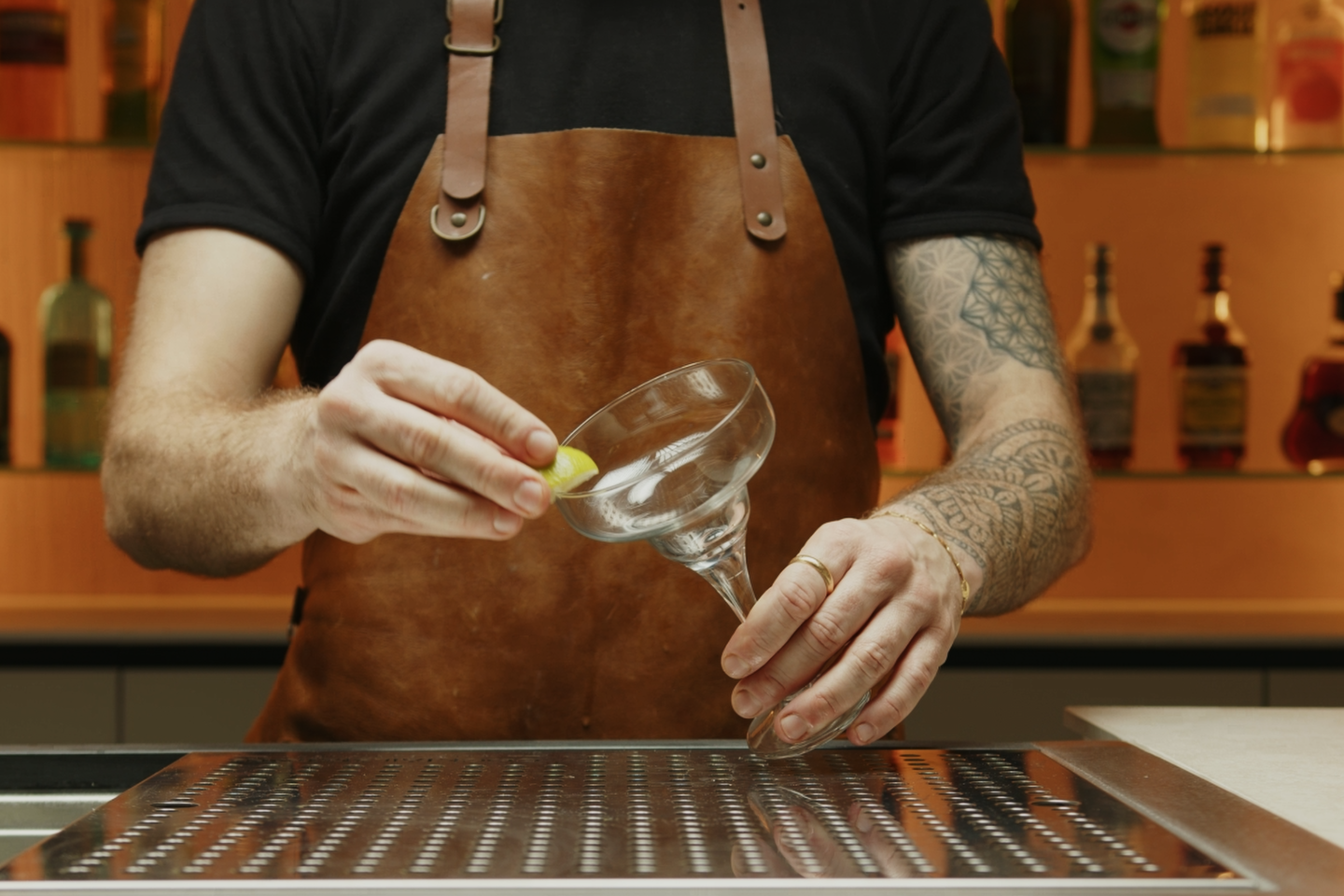 <p>Start by taking a Margarita glass and rubbing the rim with a lime wedge. </p>
