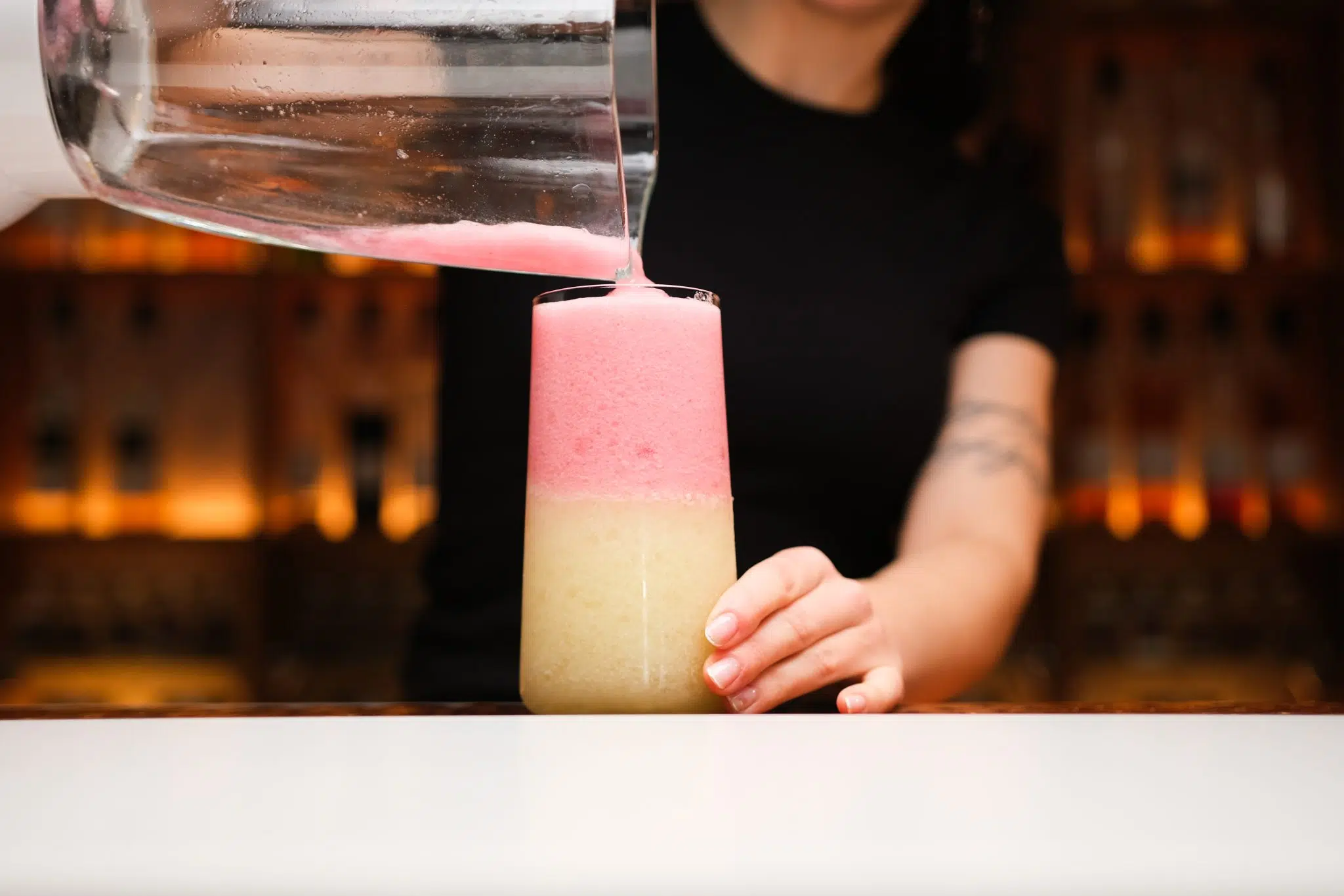 <p>Gently layer the Strawberry Daiquiri mixture on top of the Piña Colada layer in the glass.</p>
