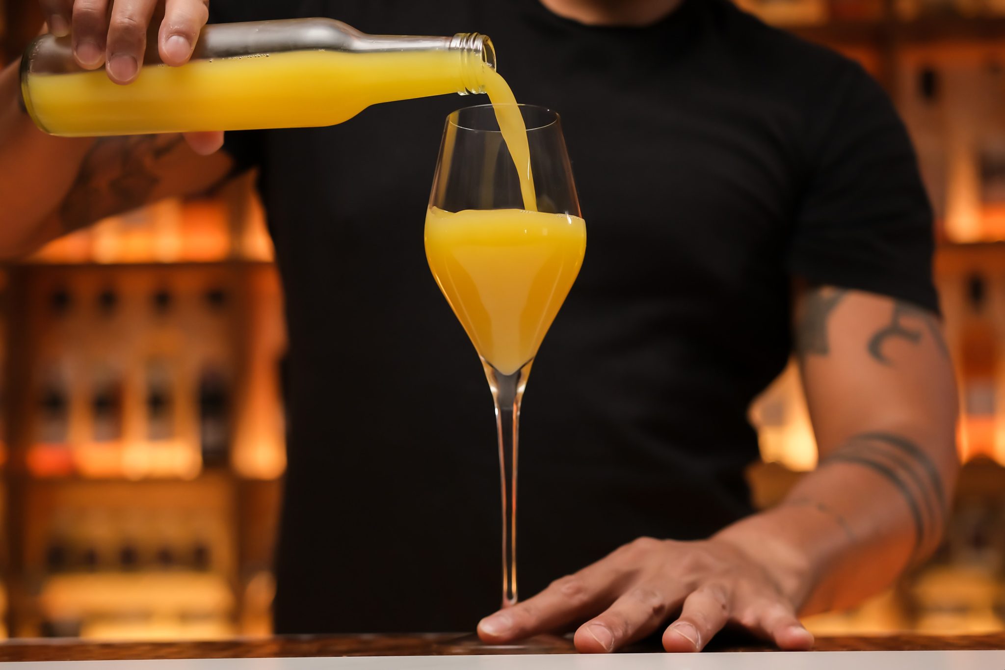 <p>Pour 2 ounces of freshly squeezed and chilled orange juice into the Champagne flute.</p>
