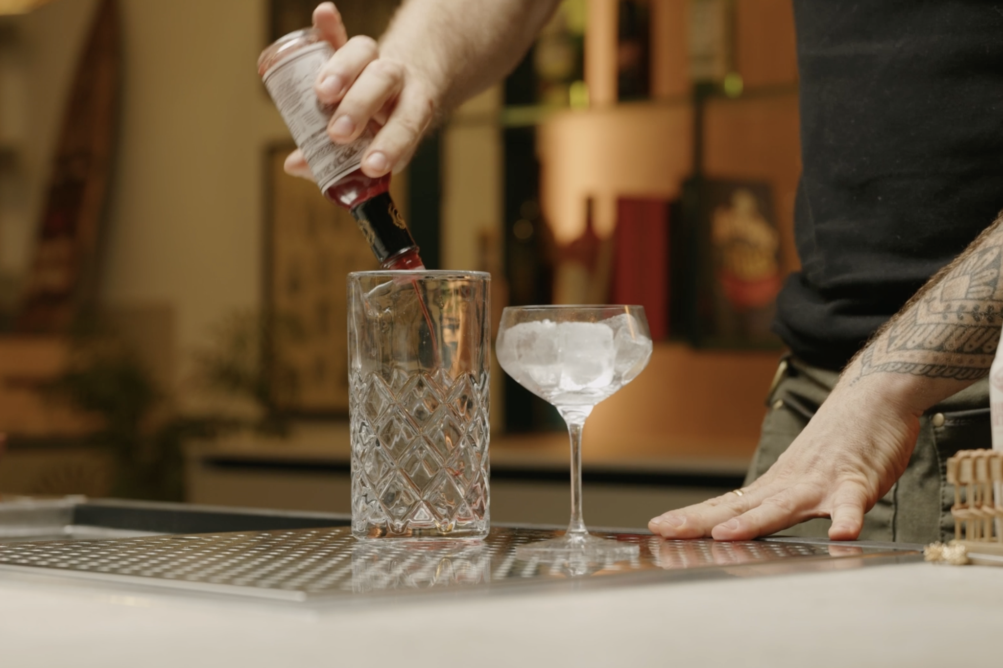 <p>Add 2 dashes of Peychaud bitter in a mixing glass, adding aromatic depth and a hint of bitterness.</p>