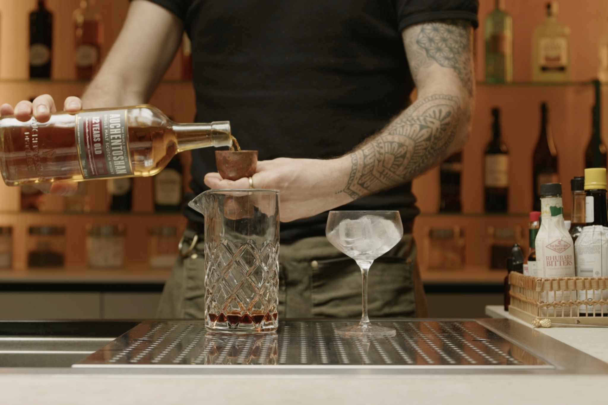 <p>Pour 1½ oz of single malt scotch whisky into the mixing glass, providing a robust base for the cocktail.</p>