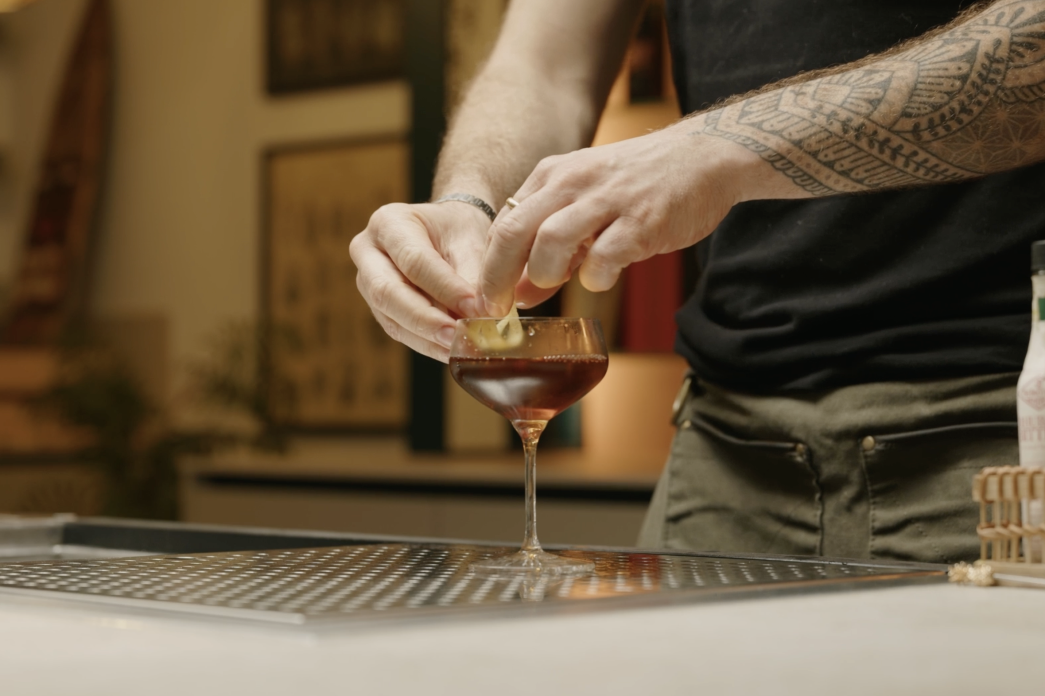 <p>Place a lemon twist into the glass for garnish, offering a citrusy aroma and visual appeal.</p>