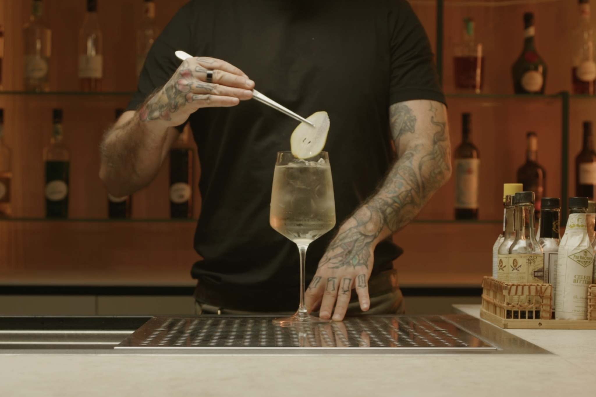 <p>Place a pear slice into the glass for garnish, enhancing both the presentation and aroma.</p>