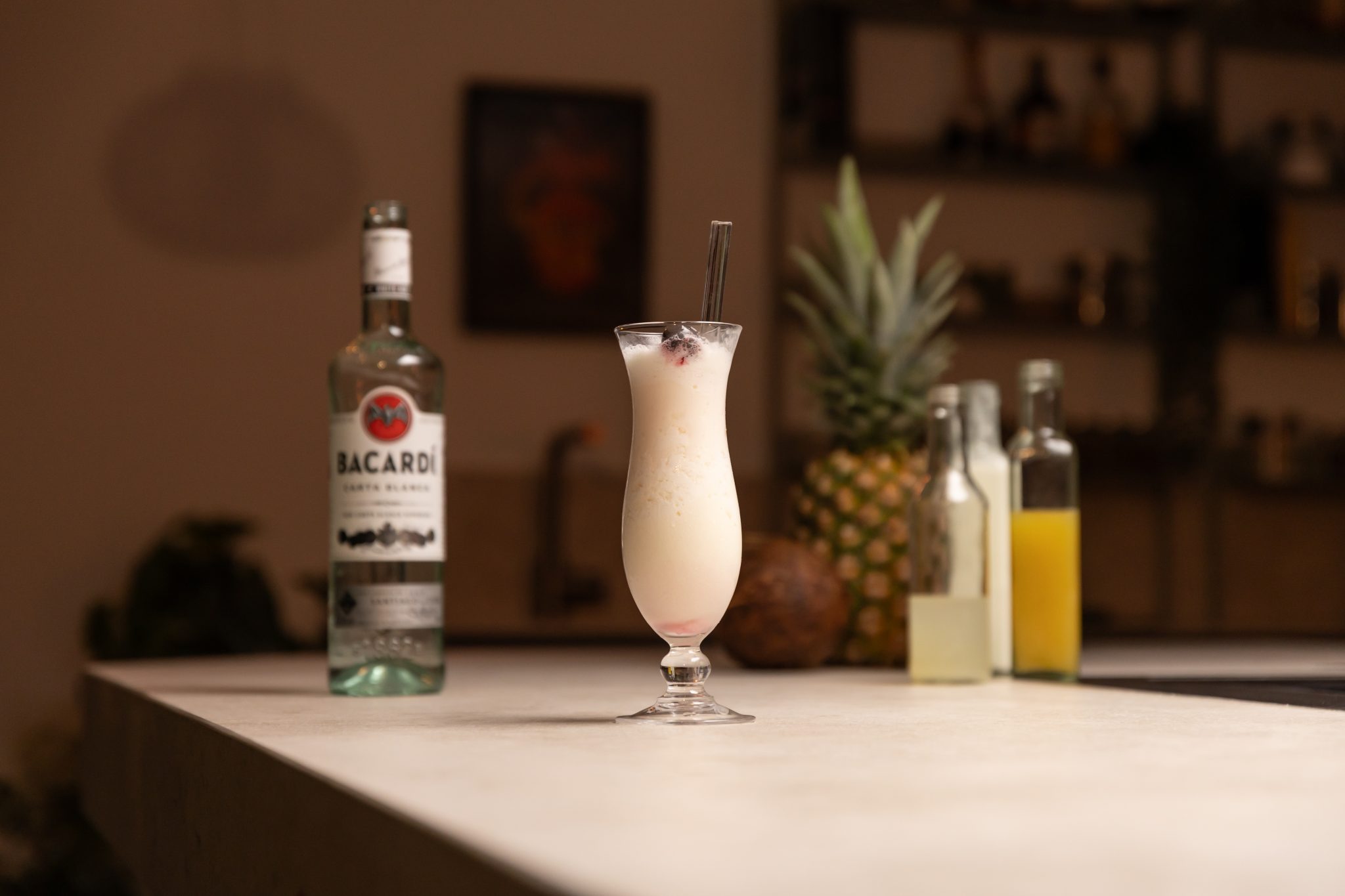 White Rum, coconut cream, coconut, pineapple, pineapple juice, and lime juice laid out on a white bar table