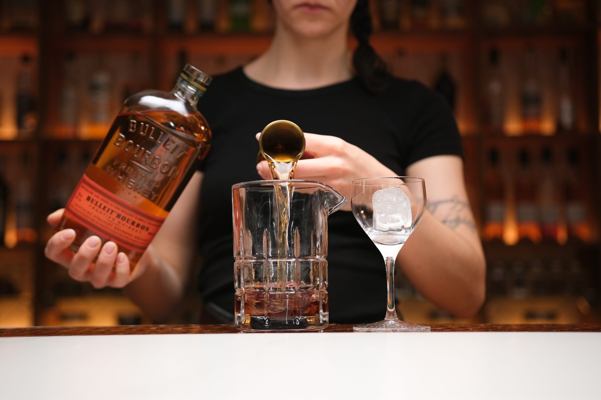 <p>Pour Bourbon into the mixing glass.</p>
