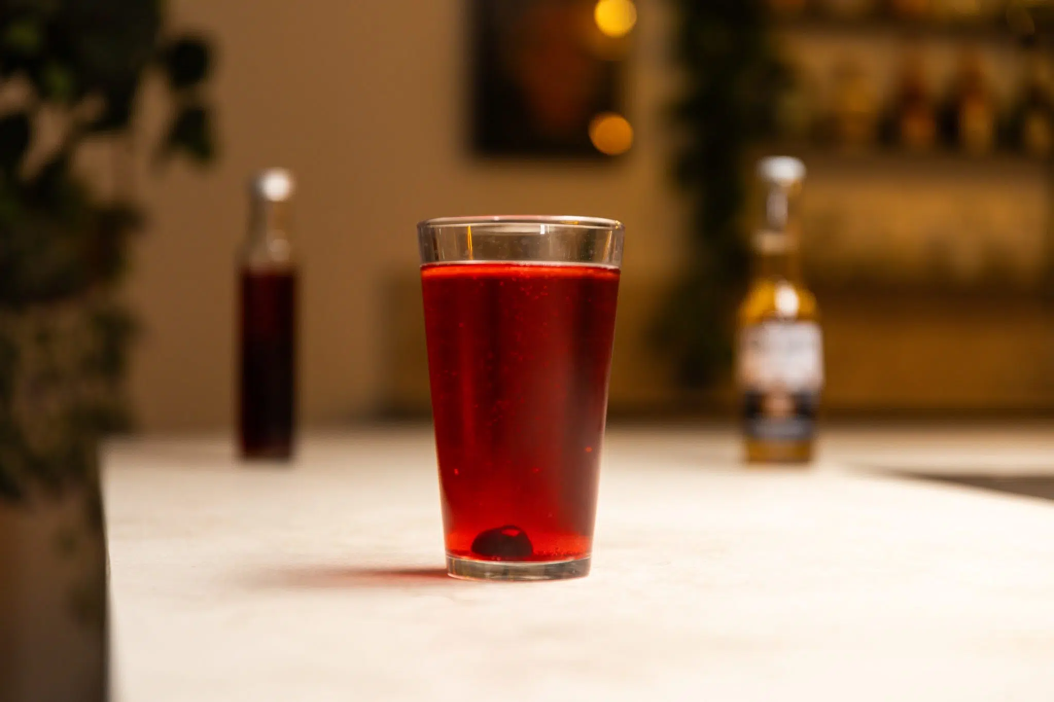 Beer and grenadine laid out on a white bar table