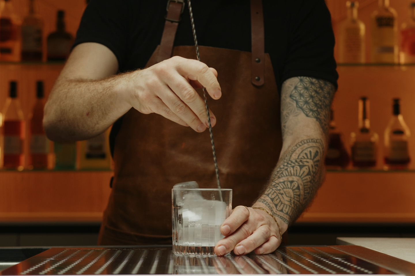 <p>Begin by preparing your glass: Fill an Old Fashioned glass with ice cubes and stir the ice for a few seconds to thoroughly chill the glass. Set the glass aside, allowing it to stay chilled while you prepare the cocktail.</p>