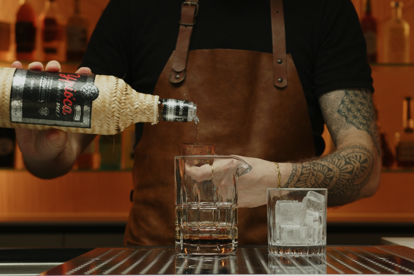 <p>Next, measure and pour 1 ⅔ ounces of Cachaça into the mixing glass. This Brazilian spirit, made from fermented sugarcane juice, provides a distinctive, slightly grassy flavor that forms the backbone of the cocktail.</p>