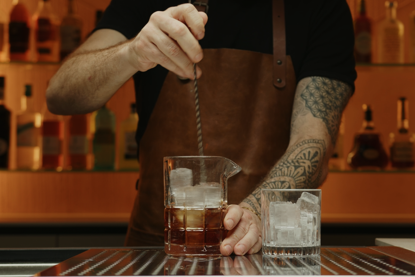 <p>Using a bar spoon or a long stirrer, stir the mixture for about 15-20 seconds. This process chills and slightly dilutes the drink, balancing the flavors. Taste the mixture and stir a bit more if you feel like more dilution is necessary.</p>