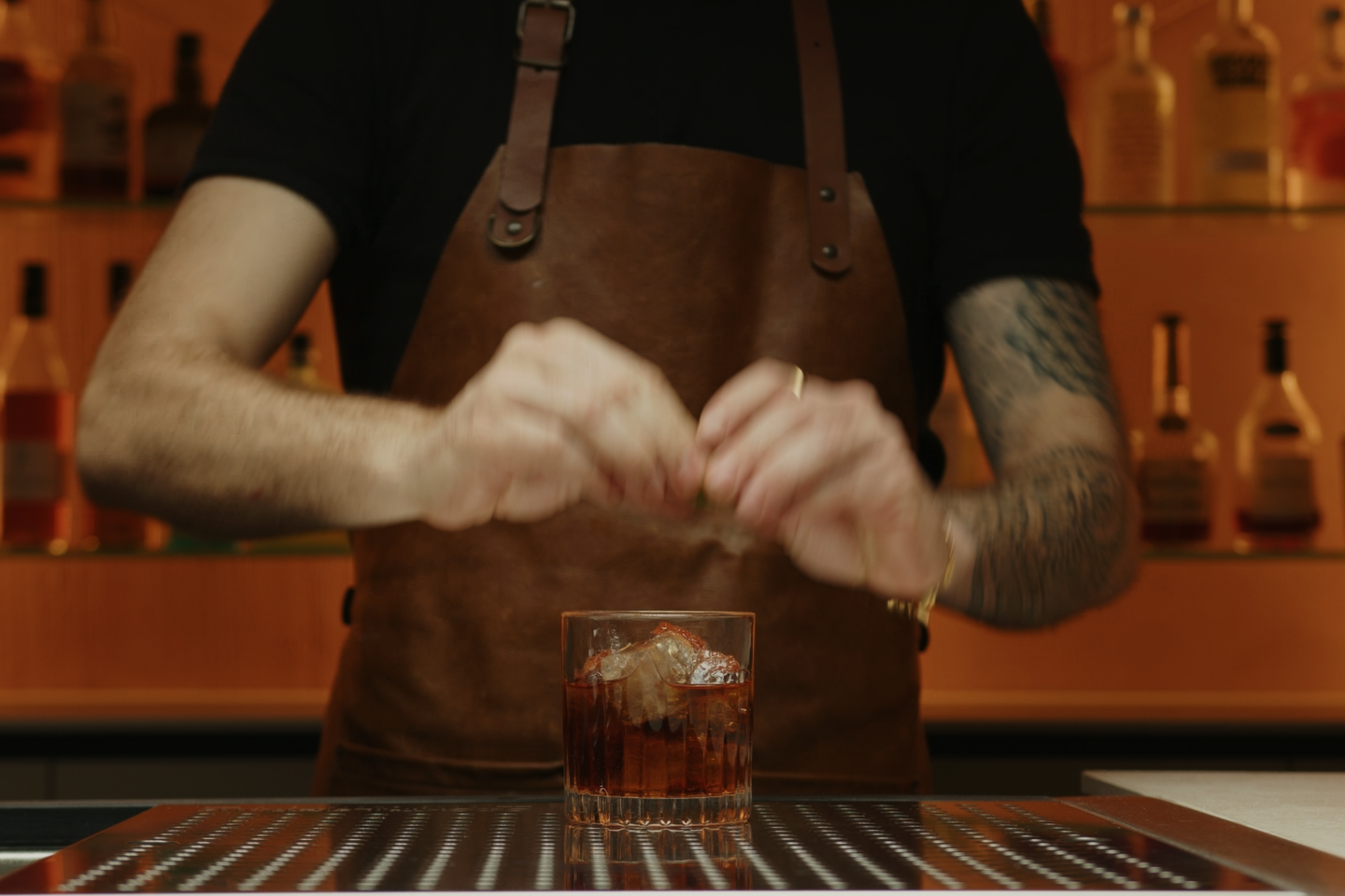 <p>For the garnish, take a twist of lime or an orange zest. Express the oils from the zest by gently squeezing it over the top of the drink; this adds a fresh, aromatic citrus note. </p>
