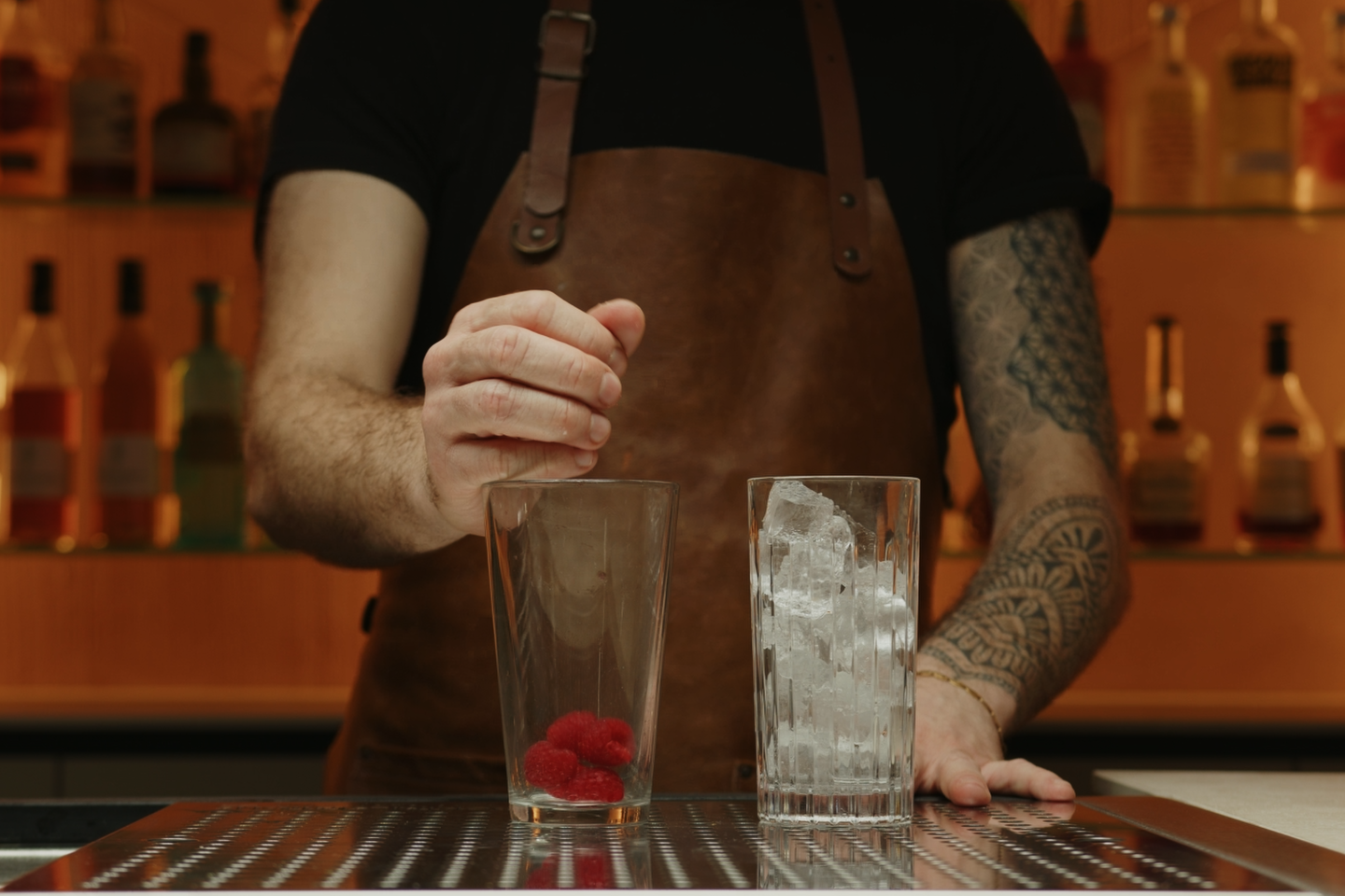 <p>In your cocktail shaker, add 6-8 fresh raspberries. The raspberries will provide a sweet and tangy base for your Raspberry Collins.</p>