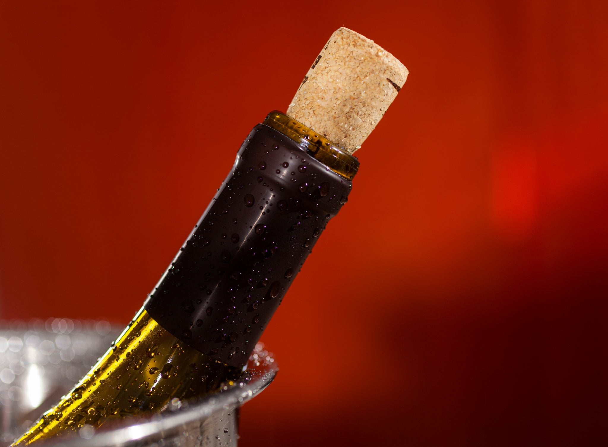 A close shot of the neck of a wine bottle recorked with a cork