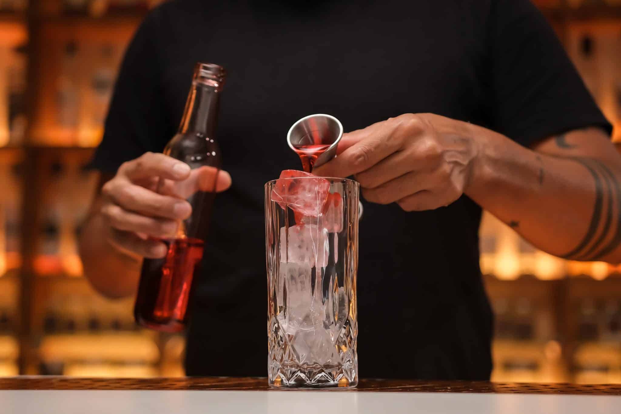 <p>Pour 1 oz of Grenadine over the ice to lay the foundation for the cocktail’s sweetness.</p>
