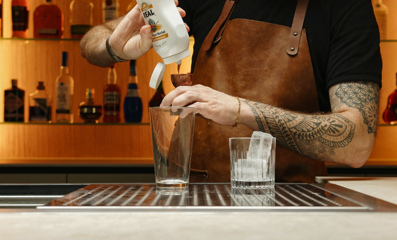 <p>Measure and pour ½ oz of agave nectar into the cocktail shaker.</p>
