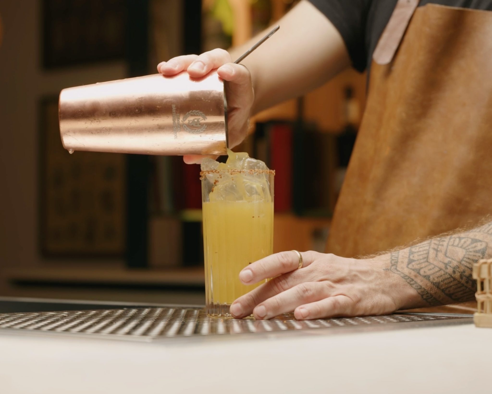 <p>Then, use the cocktail strainer to strain the cocktail into the ice-filled glass.</p>
