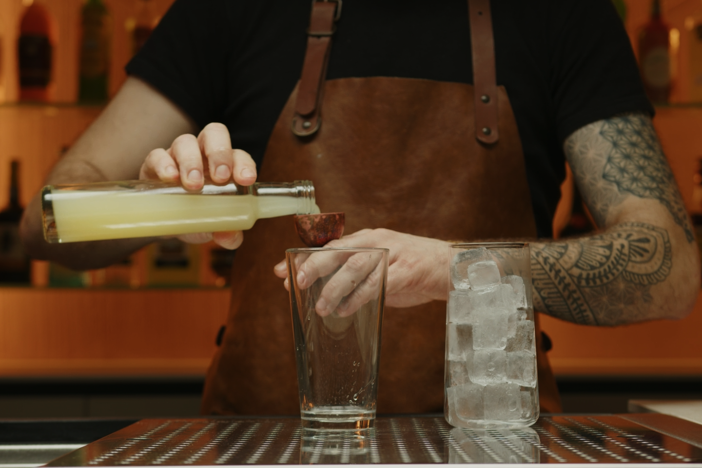 <p>Pour ½ ounce of lime juice into the shaker. This will add a citrusy note to the cocktail, balancing out the rest of the ingredients.</p>
