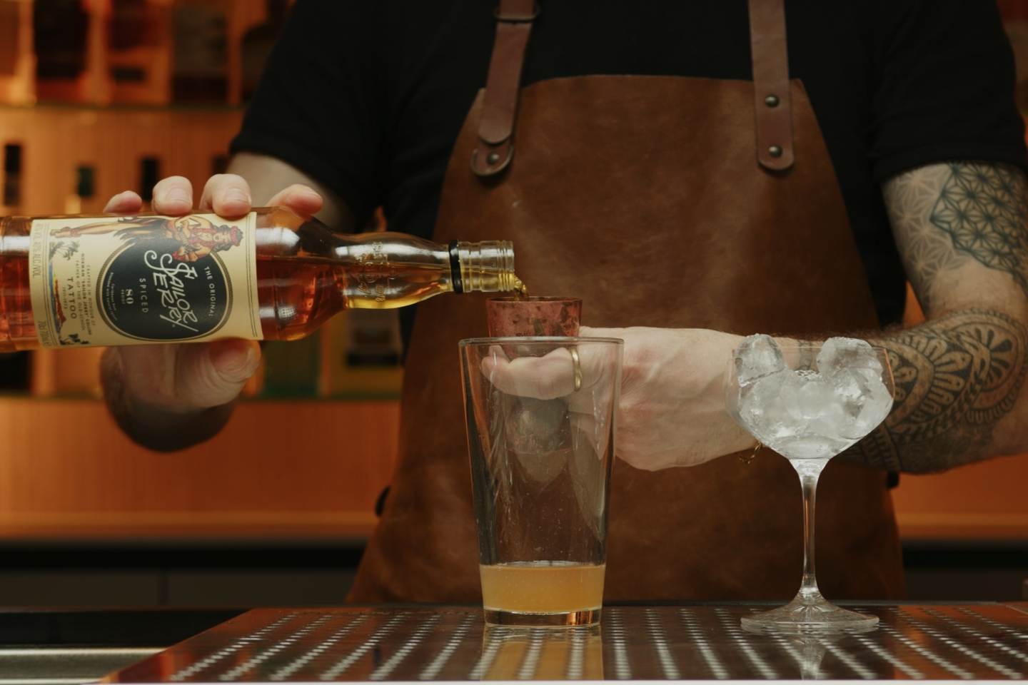 <p>Finally, measure and pour 2 ounces of spiced rum into the shaker. The spiced rum serves as the base spirit, adding depth and complexity with its rich, spiced flavors.</p>