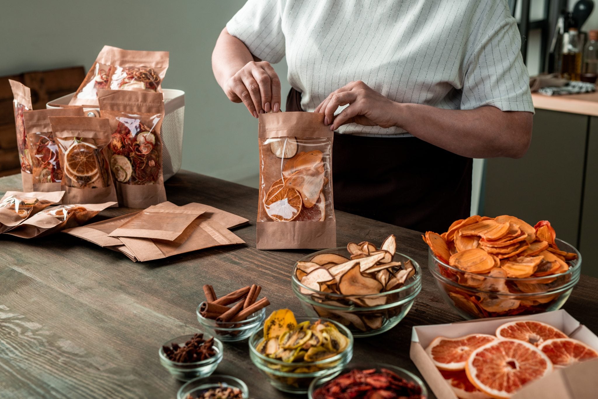 A shot of a woman storing dehydrated garsnishes in airtight bags