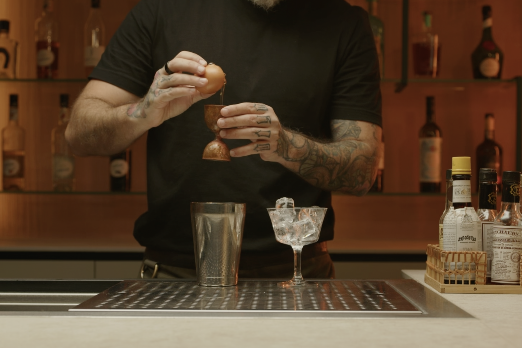 <p>Crack an egg and add the egg white to the shaker, creating a frothy, smooth consistency.</p>