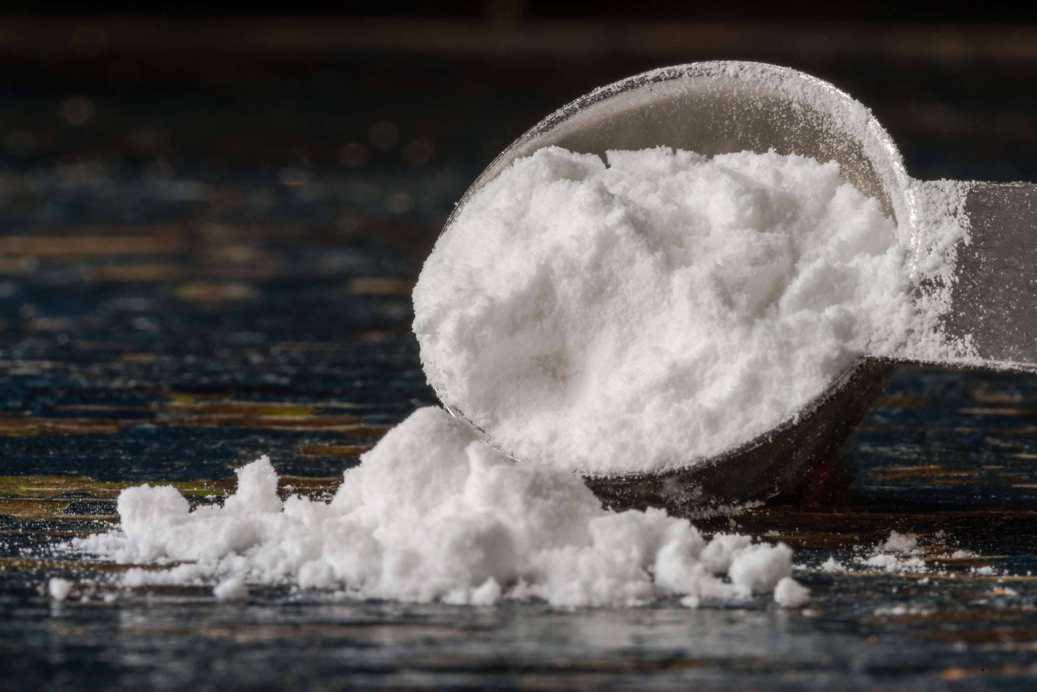 A shot of a plastic spoon with tartaric acid