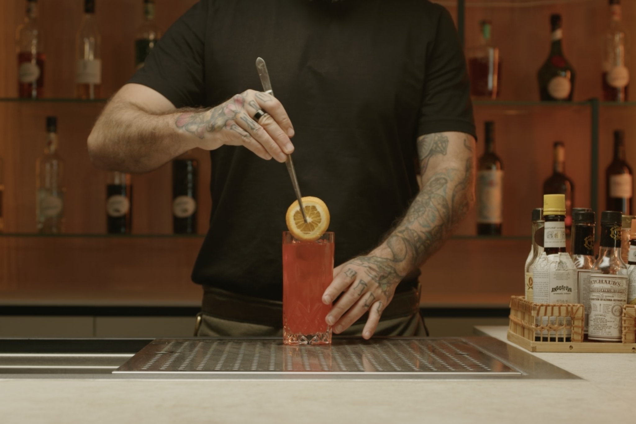 <p>Place an orange slice or twist into the glass for garnish, enhancing the presentation and adding a hint of citrus aroma.</p>