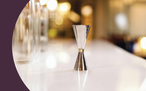 A shot of a jigger on a white bar table