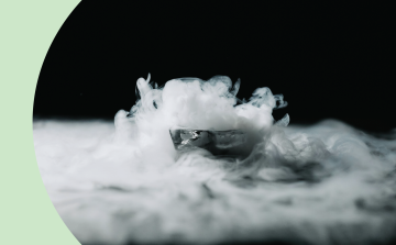 A shot of a dry ice in a metal bowl realising a lot of 'smoke', changing from solid to gas form