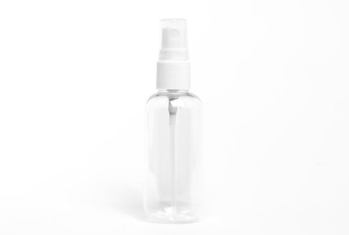 A shot of a white spray bottle on a white background